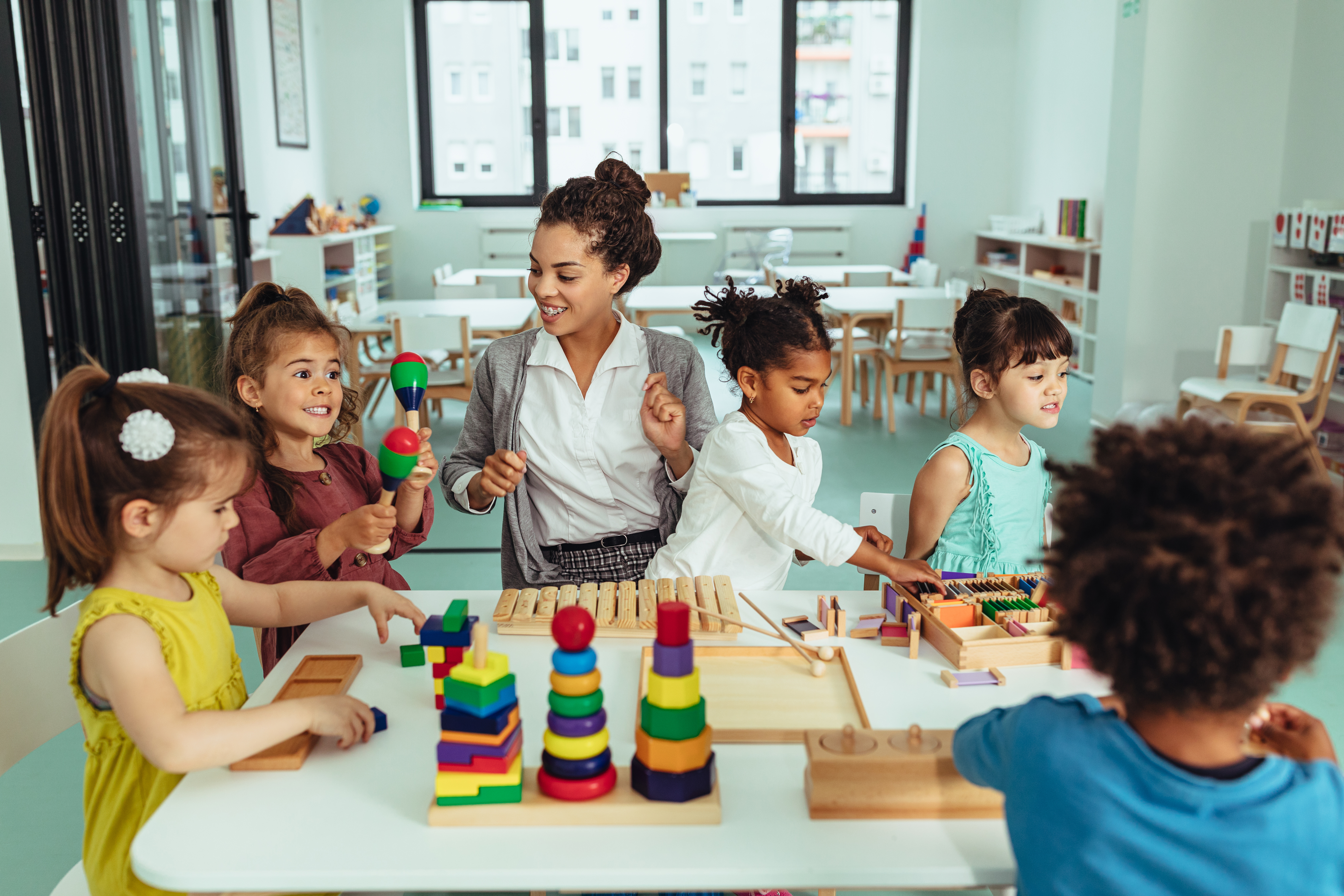 Educator playing with children in a childcare centre